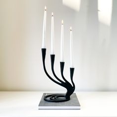 a black and white candelabra with five candles