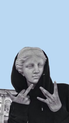 a statue of a woman with her hands in front of her face and the building behind her