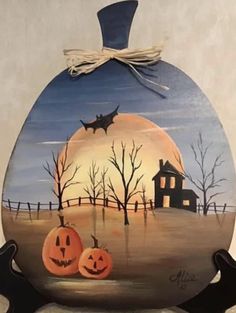 an egg painted to look like a halloween scene with jack - o'- lanterns