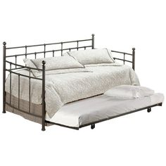 a metal daybed with white sheets and pillows on the bottom bed, against a white background