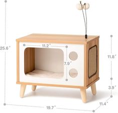 a white and wood toy microwave oven with measurements