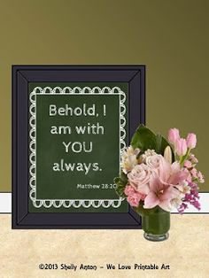 a vase filled with pink flowers next to a chalkboard that says behold, i am with you always