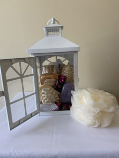 a small white lantern with soap and other items in it