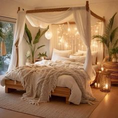 a bed with white linens and lights on the headboard is in front of a window