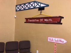 two chairs sitting in front of a sign that says foundation of worth