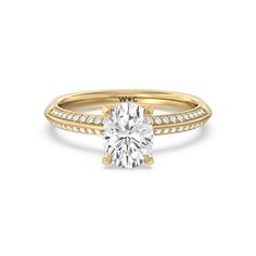 a yellow gold engagement ring with a cushion cut diamond and pave set diamonds around the band