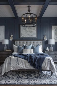 a bedroom with blue walls and white bedding, chandelier above the bed