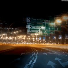 an empty city street at night with lots of lights