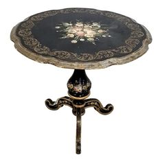 a black and gold table with flowers on it