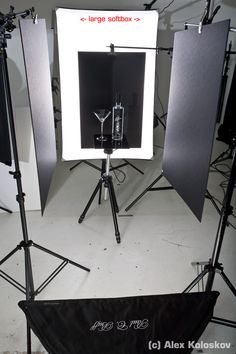 an empty photo studio set up with lights and lighting equipment in front of the camera