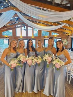 a group of women standing next to each other holding bouquets