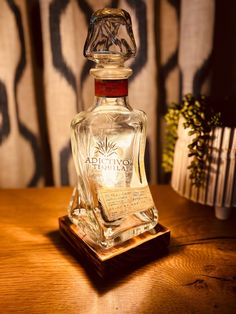 a glass bottle sitting on top of a wooden table