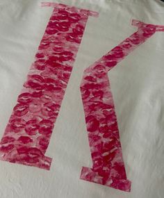 the letter k is made out of tissue paper and then cut into smaller pink letters