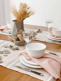 the table is set with dishes and silverware