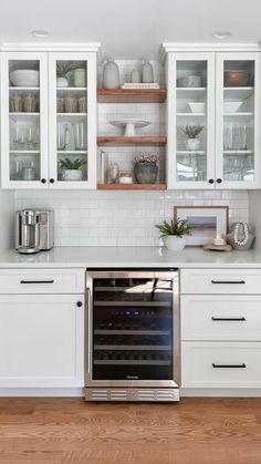 a kitchen with white cupboards and stainless steel oven in it's center island