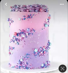 a pink and purple cake with sprinkles on it