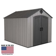 a gray shed with the american flag in the back ground and an image of it