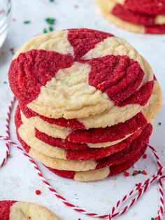 red and white cookies stacked on top of each other with candy canes around them