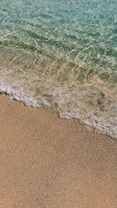 an ocean view with waves coming in to the shore