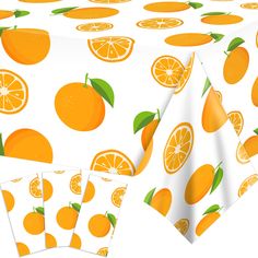 an image of oranges on a tablecloth with placemats and napkins