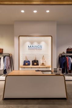 a store with clothes and handbags on display in front of a window that says margos