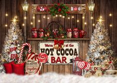 christmas decorations and candy canes in front of a hot cocoa bar sign