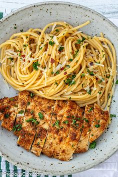 a white plate topped with pasta and chicken