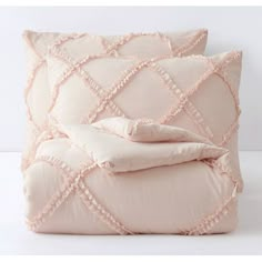 two pink pillows on top of each other