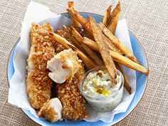 fried fish and french fries on a blue plate with a small bowl of ranch dressing