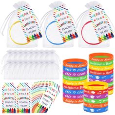 rainbow party supplies including plastic cups, napkins and candy bar wrappers are shown