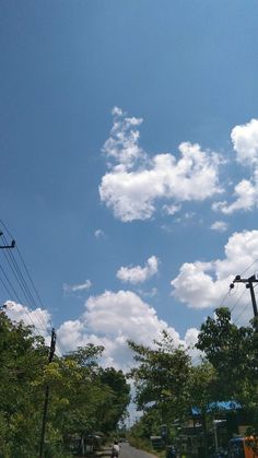 the sky is filled with clouds and some power lines