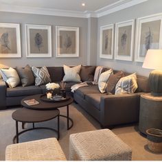 a living room filled with lots of furniture and pictures on the wall above it's coffee table