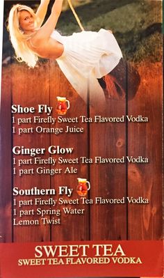 an advertisement for sweet tea flavored vodka on the side of a wooden fence in front of a woman