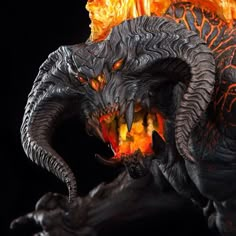 a close up of a statue with flames coming out of it's mouth and eyes