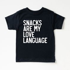 Looking for a cute tee for your kids? We have the perfect Snacks Are My Love Language graphic tee addition to their closet! Also available in toddler tees. Popular Shirts Vinyl, Funny Letter Print T-shirt For Playtime, Cute Black T-shirt With Funny Text, Casual Tops With Funny Text For Playtime, Black Letter Print T-shirt For Playtime, Black T-shirt With Letter Print For Playtime, Toddler Cricut Shirts, Toddler Shirt Ideas, Toddler Tshirt Ideas