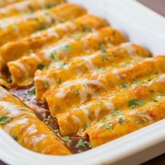 an enchilada dish is shown in a white casserole dish