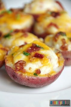 baked potatoes with cheese and bacon are on a white plate