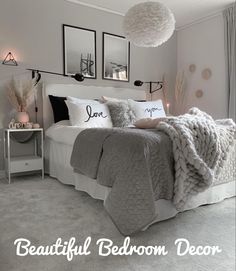 a bedroom decorated in neutral tones with white and black accents