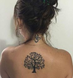 a woman with a tree tattoo on her back