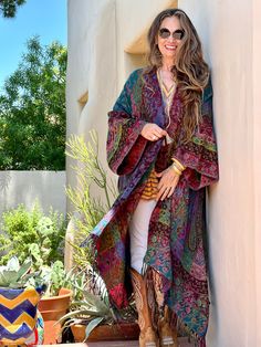 Embark on a cultural odyssey with our Joseph's Reversible Boiled Wool Paisley Kimono Coat – a mesmerizing fusion of Indian artistry and history. Woven by skilled artisans in India, this one-size marvel envelops you in a kaleidoscope of teal, purple, green, fuchsia, red, and orange. The rich heritage of paisley unfolds, paying homage to ancient traditions. Boiled wool's softness and resistance to wrinkles redefine luxury, making this kimono your perfect travel companion. Stand out in a crowd, emb Handmade Long Multicolor Kimono, Handmade Multicolor Festival Kimono, Multicolor Bohemian Kimono For Festivals, Long Multicolor Kimono For Festivals, Traditional Multicolor Long Kimono, Traditional Multicolor Fall Kaftan, Traditional Long Multicolor Kimono, Multicolor Festival Kimono, Traditional Multicolor Festival Kimono