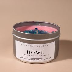 | Hand-poured Soy Wax Candle inspired by Howl from Howl's moving castle | It comes with baby pink wax with chrome blue & green biodegradable glitter on top to remind you of the colours of Howl's famous jacket.  Scent Notes - Neroli - Honeysuckle - Jasmine  --- Please Note: Made from all-natural soy wax that allows for a strong scent throw and easy clean-up. Most fragrance oils are Phthalate free.  Wicks are 100% cotton and contain no zinc. Frosting and small imperfections on the surface are norm Howl's Moving Castle Decor, Howl Howl's Moving Castle, Castle Decor, Biodegradable Glitter, Travel Candles, Howl's Moving Castle, Scent Notes, Howls Moving Castle, Soy Wax Candle