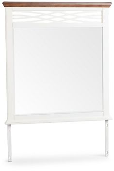 a white wooden frame mirror on top of a shelf