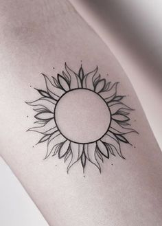 a black and white photo of a sunflower tattoo