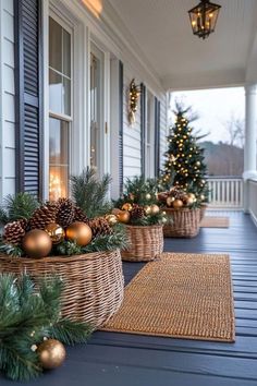 christmas decorations on the front porch with pine cones and gold baubles in baskets