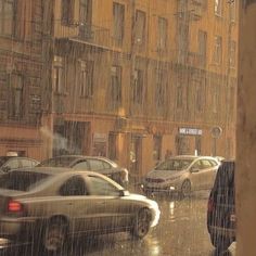 a city street filled with lots of traffic on a rainy day in the middle of winter