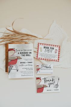 two small business cards are sitting next to each other on a white table cloth and some twine