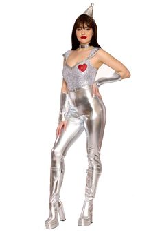 a woman dressed in silver is posing for the camera with her hands on her hips