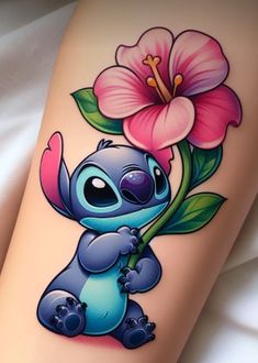 a tattoo with a cartoon character holding a flower on it's leg and the word lil