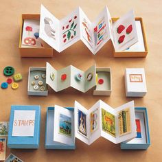 an open book sitting on top of a table next to some buttons and magnets