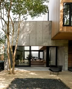 a modern house with trees in front of it